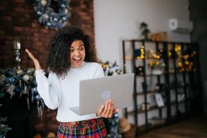 Nice attractive lovely overjoyed crazy woman holding in hands laptop, goal achievement photo