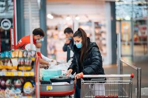 Young woman buying goods in a supermarket photo