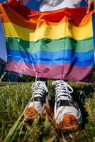 Cropped photo of young woman with LGBT pride flag.