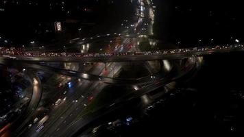 Aerial view of highway interchange at night, timelapse. photo