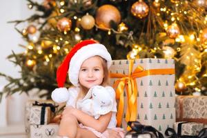 Happy little girl hugs her favorite toy in the room photo