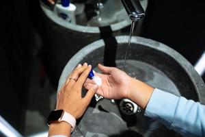 Man washing hands to protect against the coronavirus photo