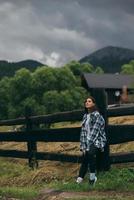 A young attractive Caucasian female stand by a fence photo