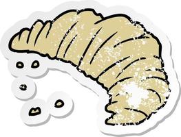 distressed sticker of a cartoon croissant vector