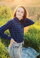 Portrait of a beautiful young woman on meadow photo