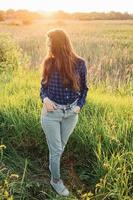 Portrait of a beautiful young woman on meadow photo