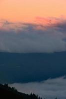 Dawn in the mountains, clouds covered the slopes of the Carpathians. photo
