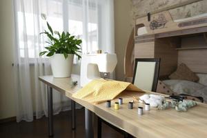 A white sewing machine stands on the table photo