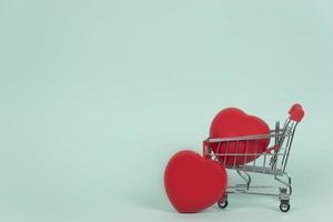 A shopping trolley with red hearts in it. Copy space. Healthcare concept photo