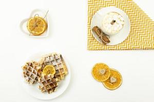 Early breakfast coffee with marshmallows and a stick of cinnamon and Belgian waffles photo