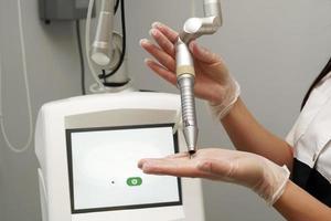 A modern laser device is ready for the antiaging gynecological procedures in a clinic photo