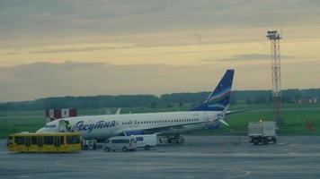 NOVOSIBIRSK, RUSSIAN FEDERATION JUNE 14, 2019 - Airport crew supervising passengers boarding Yakutia Airlines Boeing 737 VQ BIZ in Tolmachevo airport, Novosibirsk video