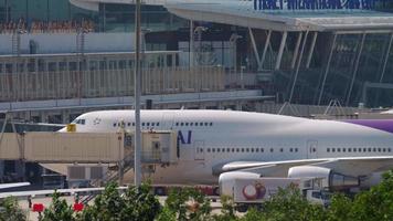 PHUKET, THAILAND NOVEMBER 29, 2019 - Thai Airways Boeing 747 HS TGG in the process of passenger disembarkation through the jet bridge at Phuket International airport video