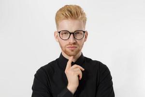 Young entrepreneur Generate Business Ideas. Close up of thinking Man in black shirt and glasses isolated, copy space. Self improvement, serious male face. Redheaded guy with red beard, hairstyle photo