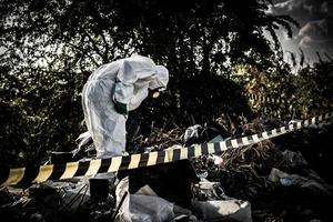 Asian scientist wear Chemical protection suit check danger chemical,working at dangerous zone,Collecting samples in case of Corona virus investigation outbreaked from China. photo