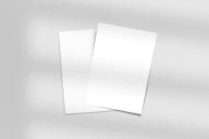 Realistic top view cover and opened portrait A4 or A5 magazine or brochure booklet for stationery and branding. Mockup template isolated light grey background and leaf shadow overlay. 3D rendering. photo