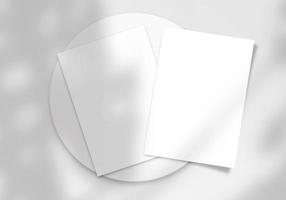 Realistic top view cover and opened portrait A4 or A5 magazine or brochure booklet for stationery and branding. Mockup template isolated light grey background and leaf shadow overlay. 3D rendering. photo