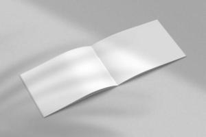 Realistic top view cover and opened portrait A4 or A5 magazine or brochure booklet for stationery and branding. Mockup template isolated light grey background and leaf shadow overlay. 3D rendering. photo