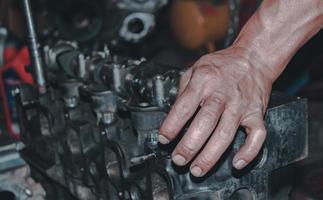 The mechanic is checking the engine. photo