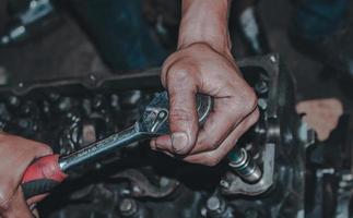 The mechanic is checking the engine. photo