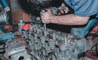 The mechanic is checking the engine. photo