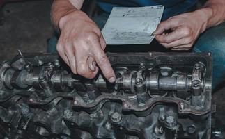 The mechanic is checking the engine. photo