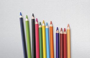 colored pencils on a canvas texture background photo