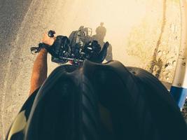 Front top firts person point of view bicycle handlebars with road background. Cyclist wallpaper background photo