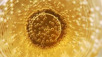 Abstract background of golden liquid in a glass full of air bubbles. photo