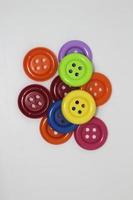 Colorful children's toys like buttons on clothes isolated on white background photo