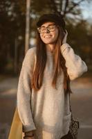 Attractive, young brunette with long hair walking autumn park. photo