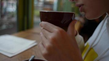 Beautiful young woman with a cup of coffee at a cafe photo