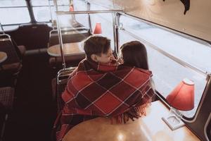 Loving young couple in winter time sitting in a cafe photo