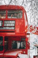 Loving young couple have fun in the red bus photo