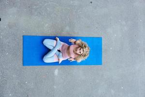 Young slim blond woman making yoga exercises photo