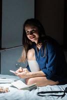 Side view woman working in dark bedroom. photo