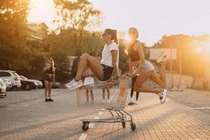 Friends ride on carts, near the supermarket photo