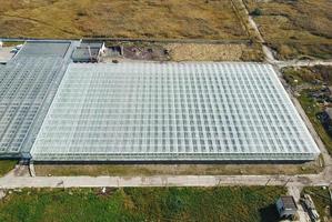 Greenhouses field. Flying over the greenhouses. photo