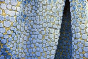 Detailed close up view on samples of cloth and fabrics in different colors found at a fabrics market photo