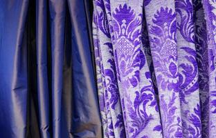 Detailed close up view on samples of cloth and fabrics in different colors found at a fabrics market photo