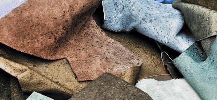 Detailed close up view on samples of cloth and fabrics in different colors found at a fabrics market photo