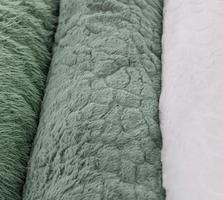 Detailed close up view on samples of cloth and fabrics in different colors found at a fabrics market photo