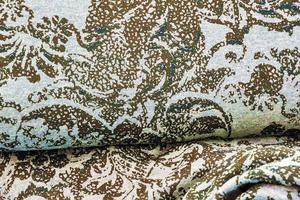 Detailed close up view on samples of cloth and fabrics in different colors found at a fabrics market photo