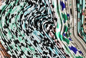 Detailed close up view on samples of cloth and fabrics in different colors found at a fabrics market photo