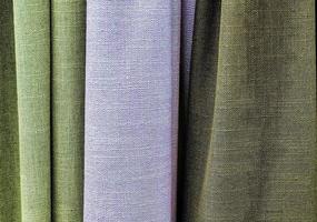 Detailed close up view on samples of cloth and fabrics in different colors found at a fabrics market photo