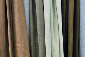 Detailed close up view on samples of cloth and fabrics in different colors found at a fabrics market photo