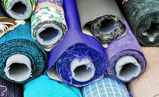 Detailed close up view on samples of cloth and fabrics in different colors found at a fabrics market photo