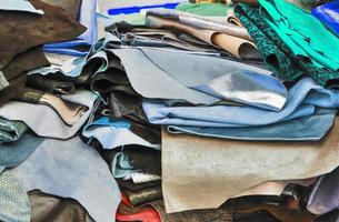 Detailed close up view on samples of cloth and fabrics in different colors found at a fabrics market photo