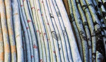 Detailed close up view on samples of cloth and fabrics in different colors found at a fabrics market photo