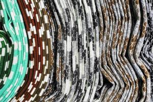 Detailed close up view on samples of cloth and fabrics in different colors found at a fabrics market photo